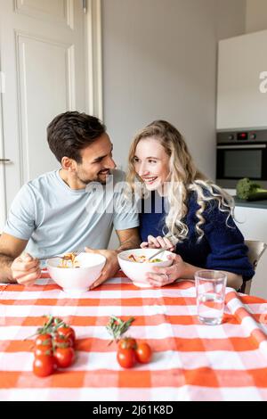 Romantic couple having food on dining table at home Stock Photo