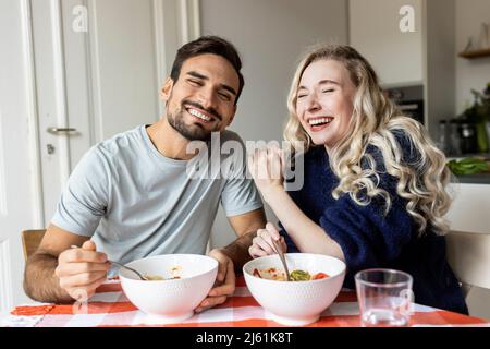 Happy couple enjoying meal at home Stock Photo