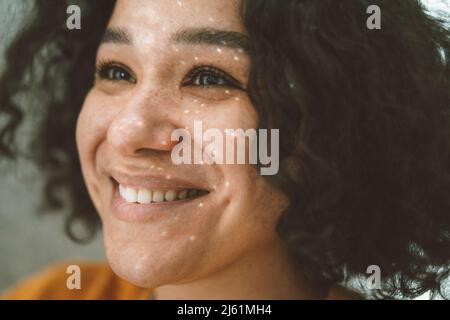 Smiling beautiful woman with light on face Stock Photo
