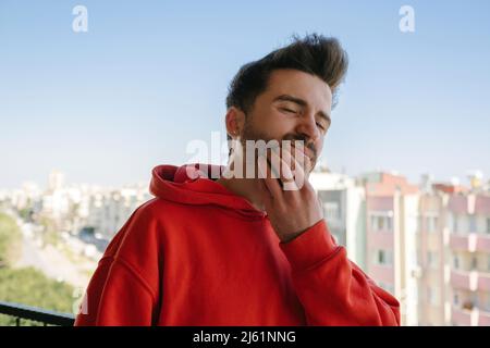 Toothache, young adult suffering a lot in the face of toothache, clenched and gritting his teeth, oral health problems Stock Photo