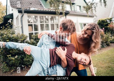Happy family enjoying together at backyard Stock Photo