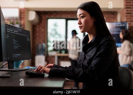 Cyber officer encrypting big chunks of data in order to secure important files. Software developer engineering an autonomous defence system using advanced artificial intelligence technology. Stock Photo