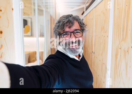 Happy senior man wearing eyeglasses at home Stock Photo