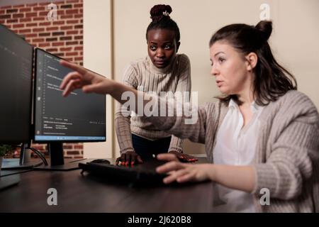 Tech engineer observing multiple system security breaches caused by overloaded storage servers. Software developers detecting cloud leak and solve it with improved application coding. Stock Photo