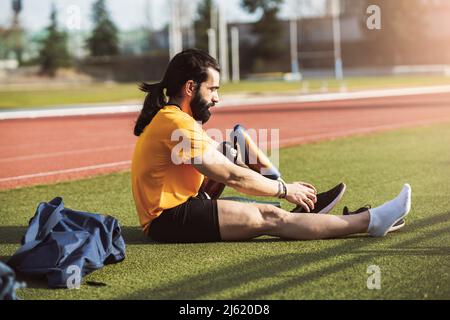 Bearded man wearing shoes on prosthetic leg Stock Photo