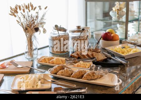 Breakfast buffet arranged on table in boutique hotel Stock Photo