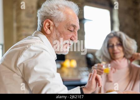 Senior couple having breakfast in boutique hotel Stock Photo