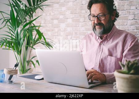 Freelancer using laptop at home Stock Photo