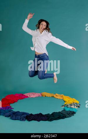 Happy woman jumping against blue sky Stock Photo - Alamy