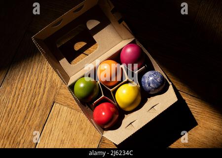 Egg carton with colorful Easter eggs Stock Photo