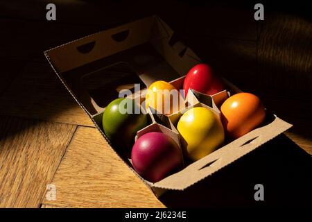 Egg carton with colorful Easter eggs Stock Photo