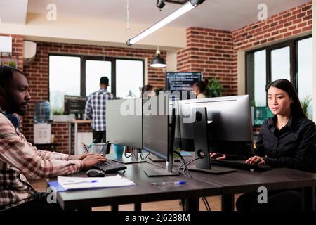 Software developer team programming encryption applications to be used as security measure. Diverse cybernetics engineers upgrading processing system application database. Stock Photo