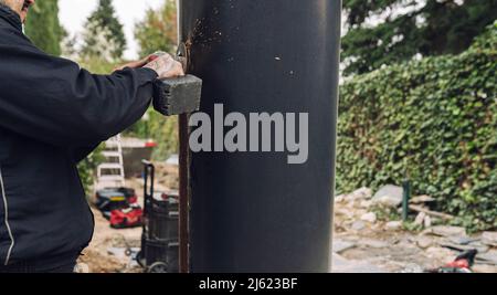 Worker using grinder working on construction site Stock Photo