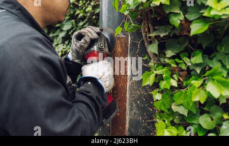 Man with circular saw working at construction site Stock Photo