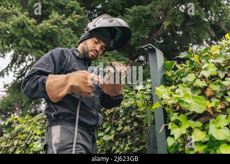 Welder standing with welding torch at construction site Stock Photo