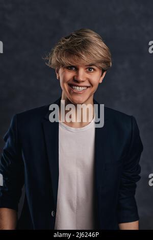 guy with modern haircut is staring at the camera Stock Photo