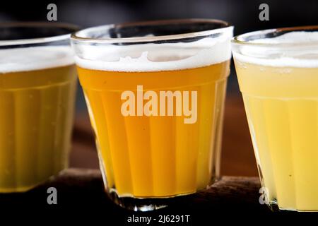 four glasses of different types of beer, draught beer, wheat beer and other types set up for tasting Stock Photo