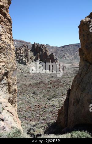 View of the caldera in the Teide National Parc through rocks on the hiking trail Sendero 3 Stock Photo