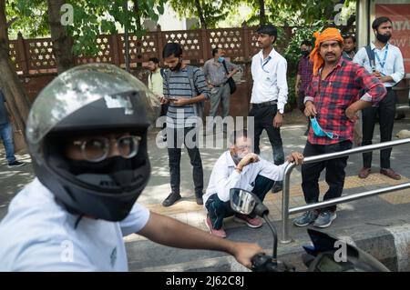 Local people watch as Prime Minister Boris Johnson's motorcade makes it's way through the streets of New Delhi during his recent visit to India. These pictures were taken from a vehicle in the PM's motorcade as it made it's way to his various engagements. Picture date: Thursday April 21, 2022. Photo credit should read: Stefan Rousseau/PA Wire Stock Photo