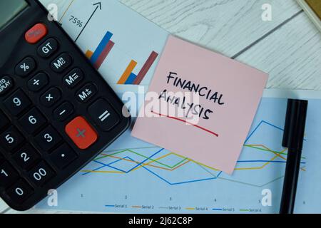 Concept of Financial Analysis write on sticky notes isolated on Wooden Table. Stock Photo