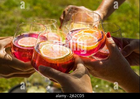 toast of six glasses with Aperol and lemon slices Stock Photo