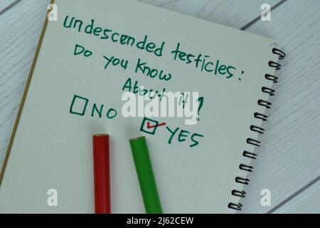 Concept of Yes, Undescended Testicles: Do you know about it? write on a book isolated on Wooden Table. Stock Photo