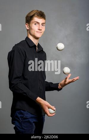 juggler boy juggles with three balls Stock Photo