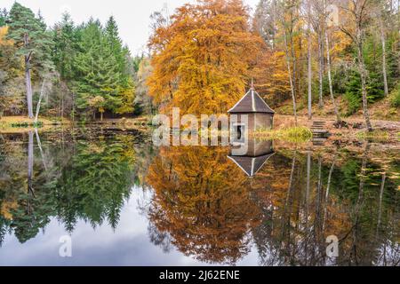 Autumn colours, Loch Dunmore boathouse in Faskally Forest near Pitlochry in Perthshire, Scotland, UK