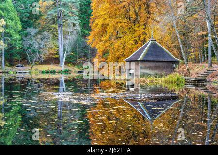 Autumn colours, Loch Dunmore boathouse in Faskally Forest near Pitlochry in Perthshire, Scotland, UK