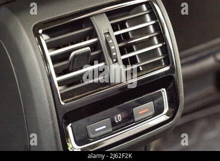 Rear air ducts with deflectors and temperature control for rear passengers in the car. 3 zone climate control Stock Photo
