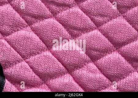 Pink new fabric in diamond pattern, background, macro. Stylish Stock Photo