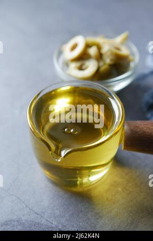olive oil and fresh olive in a container on table . Stock Photo