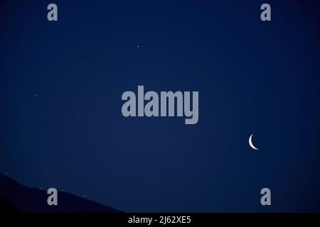 A crescent moon along with Venus is seen during a rare alignment of four planets, Venus, Jupiter, Mars, and Saturn in Srinagar. After 1,000 years, a rare and unique astronomical event is taking place where four planets including Venus, Mars, Jupiter, and Saturn aligned in a straight line in the eastern sky for around one hour before the sunrise (Photo by Saqib Majeed / SOPA Images/Sipa USA) Stock Photo