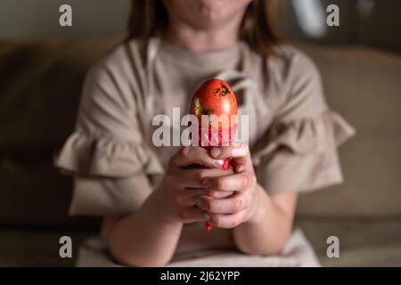 girl holding an Easter egg in a colored ice cream cone Stock Photo