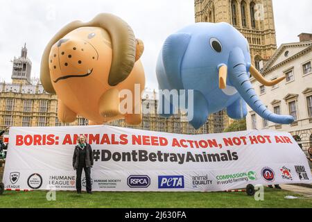 London, UK. 27th Apr, 2022. Giant elephant and lion balloons float by Parliament in support of the Animal Protection Bill, following reports that the government may drop the Animals Abroad Bill. PETA and other animal welfare organisations call on Boris Johnson to remain committed to the bill. The protest has the support of several cross party MPs. Credit: Imageplotter/Alamy Live News