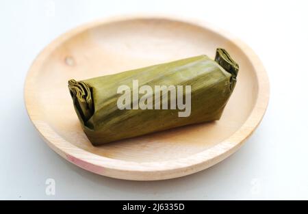 Arem-arem, Lemper, Lontong - traditional food wrapped in banana leaf on white background Stock Photo