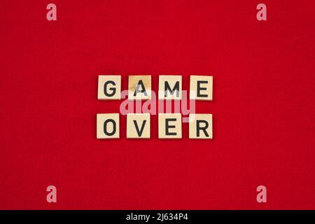 "Game over" phrase on a red felt background Stock Photo