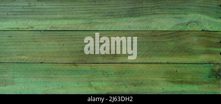 Grungy green wooden boards with rough texture as background Stock Photo
