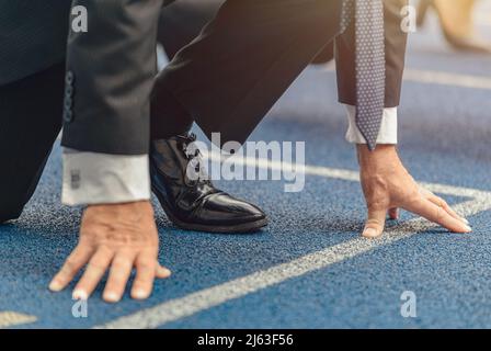 Close-up photo of businessman standing on race track Stock Photo