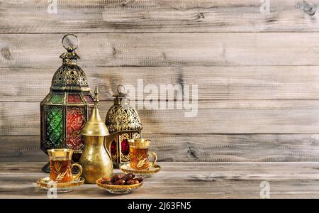 Oriental lantern, tea table on wooden background. Holidays decoration Stock Photo