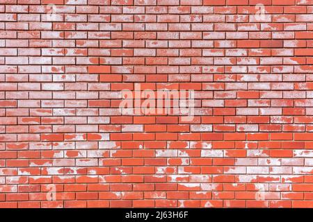 Red brick wall close-up with white salt patches for abstract detail background . Stock Photo
