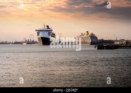 Cunard liner Queen Mary 2 passing Saga cruise ship Spirit of Adventure as she departs Southampton for New York on 24 April 2022. Southampton, England Stock Photo