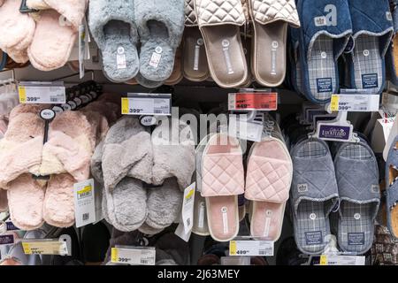 Tyumen, Russia-April 14 2022: Various brand of slippers display for sale at hypermarket. Selective focus Stock Photo