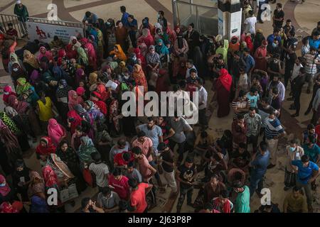 Bangladeshi people wait in a queue to collect their tickets at Komolapur railway station as Bangladesh Railways start selling advance tickets ahead of the Eid al-Fitr holiday. Eid al-Fitr is an important religious holiday celebrated by Muslims worldwide marking the end of Ramadan, the Islamic holy month of fasting. Stock Photo