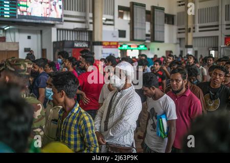 Bangladeshi people wait in a queue to collect their tickets at Komolapur railway station as Bangladesh Railways start selling advance tickets ahead of the Eid al-Fitr holiday. Eid al-Fitr is an important religious holiday celebrated by Muslims worldwide marking the end of Ramadan, the Islamic holy month of fasting. Stock Photo