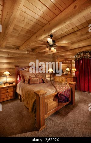 The interior of a modern log cabin bedroom. Stock Photo