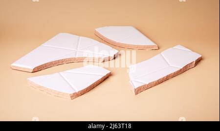 Pieces of cracked ceramic tile. Broken hope, dreams, relationship. Concept of violence and frustration in psychology. High quality photo Stock Photo