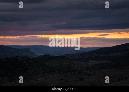 Landscape with the line of windmills on the mountain ridges at sunset , Morella, Castellon, Spain Stock Photo