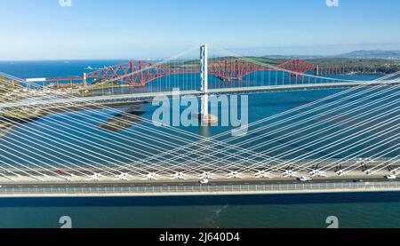 Scotland, UK. 27th April 2022. The Three bridges that cross the Firth of Forth between North and South Queensferry are isolated in this image shot from a drone.  Iain Masterton/Alamy Live News Stock Photo