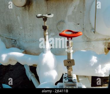 Frozen liquid nitrogen storage tank transfer valve. Close up shot, no people Stock Photo